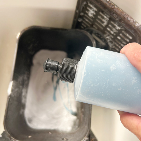 Adding dish soap to air fryer basket to remove burnt on grease