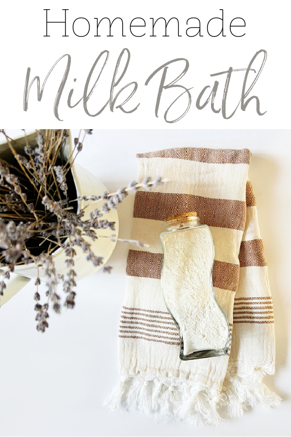 Homemade milk bath powder in a glass jar on towel