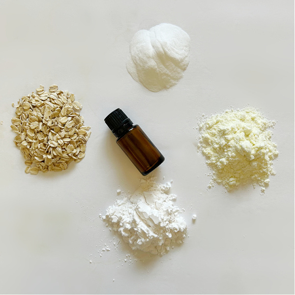 Ingredients needed to make a milk bath: oats, baking soda, powdered milk, tapioca starch and essential oil