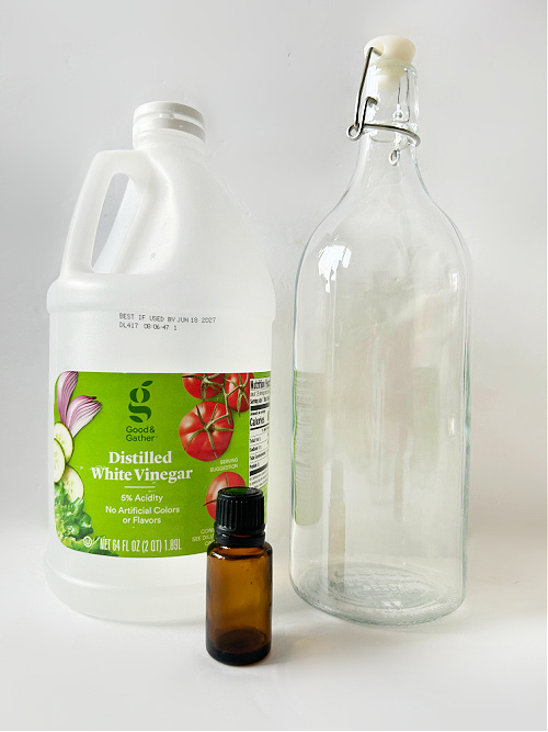 Items needed to make your own fabric softener: vinegar and essential oil with a glass bottle
