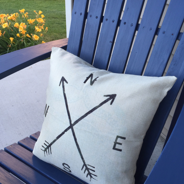 Farmhouse style throw pillow on Adirondack chair featured in a $100 porch makeover