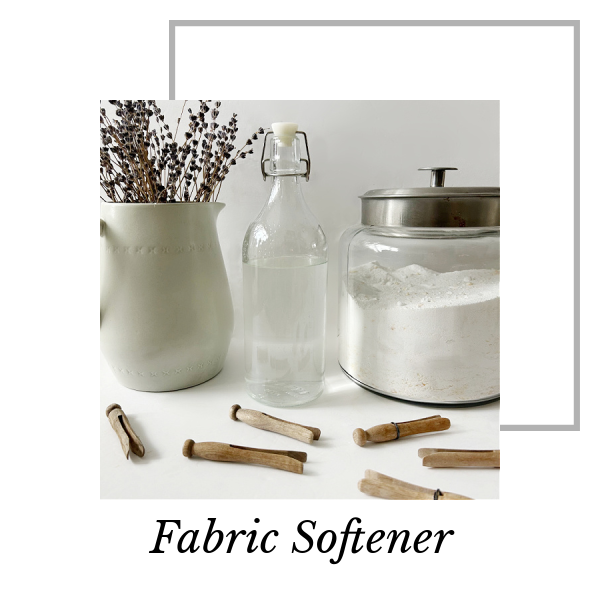 DIY Fabric Softener in glass bottle next to DIY Laundry Detergent