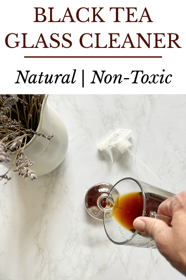 Pouring brewed black tea into a spray bottle to be used for glass cleaner